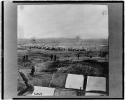 Fort Burnham, formerly Confederate Fort Harrison, James River, Virginia, with bombproof quarters(?) in foreground, soldiers, log buildings in background